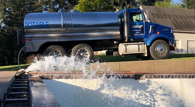No Drought water tanker filling a backyard swimming pool in the Willamette Valley