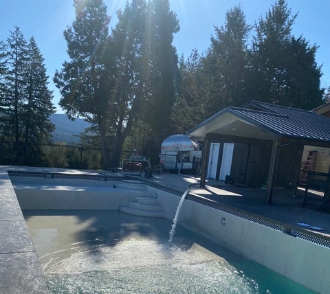 No Drought delivery hose pumping clean water into a backyard pool